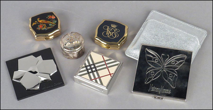 A CARTIER HAND MIRROR.: A CARTIER HAND MIRROR. With original box. Together with a sterling silver pill box, a Burberry pill box, two Stratton boxes, and a Neiman Marcus compact mirror
