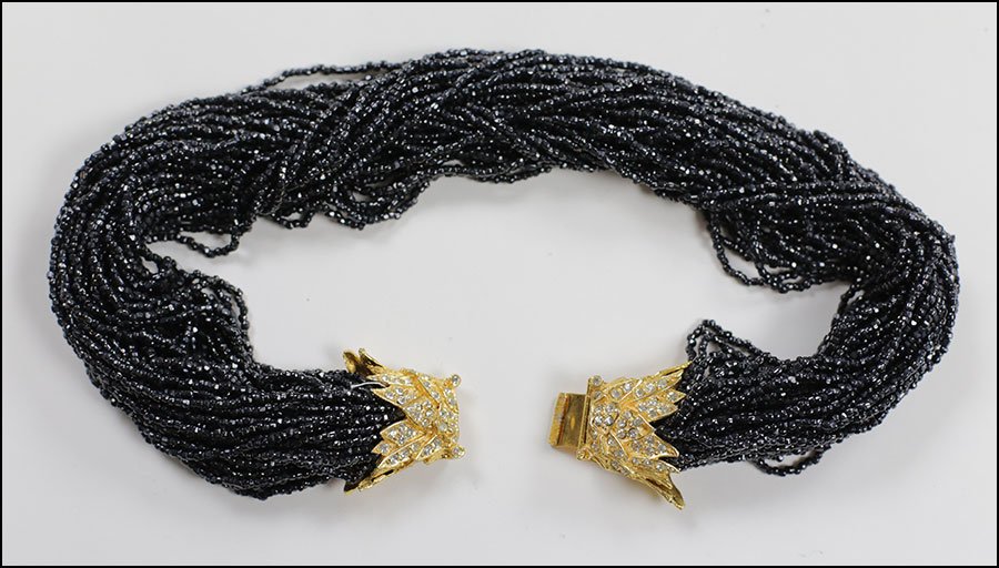 A MIMI DI N BEAD TORSADE NECKLACE.: A MIMI DI N BEAD TORSADE NECKLACE. Clasp is gold tone and white rhinestone Length: 17"