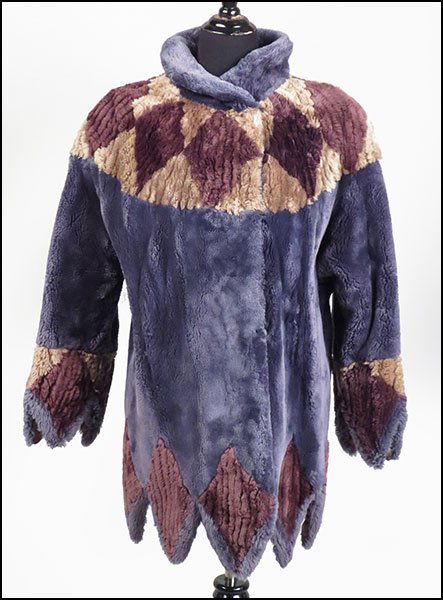 A PAT IUTO DYED SHEARED BEAVER COAT.: A PAT IUTO DYED SHEARED BEAVER COAT. Bearing a zig-zag hem, with coordinated cuffs. With a geometric design. Lined. With a hook and eye closure Size unlabeled (Approximately a size 6)
