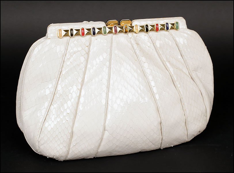 A JUDITH LEIBER WHITE SNAKESKIN CONVERTIBLE CLUTCH.: A JUDITH LEIBER WHITE SNAKESKIN CONVERTIBLE CLUTCH. With a removable strap. Bearing beaded embellishment. Includes a comb and mirror compact inside 7.25'' x 10.25'' x 2.5''