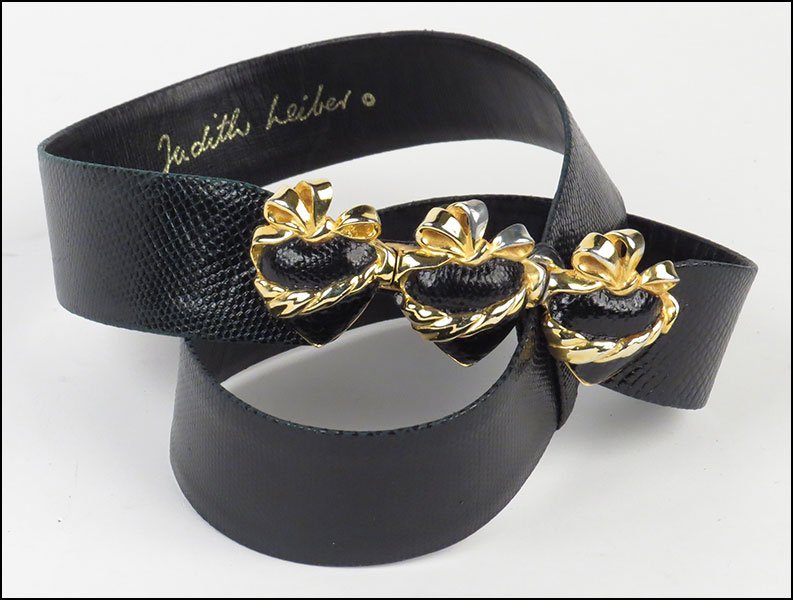 A JUDITH LEIBER BLACK LIZARD SKIN BELT.: A JUDITH LEIBER BLACK LIZARD SKIN BELT. With heart form clasp closure L: 38''