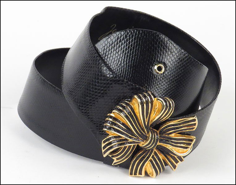 A JUDITH LEIBER BLACK LIZARD SKIN BELT.: A JUDITH LEIBER BLACK LIZARD SKIN BELT. With a bow form buckle closure L: 38.25''