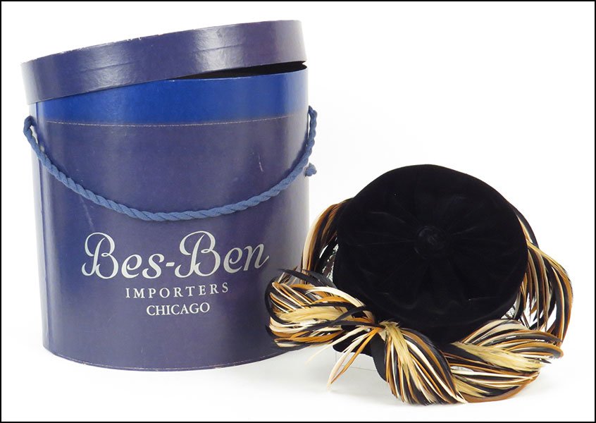 A BES-BEN BLACK VELVET HAT.: A BES-BEN BLACK VELVET HAT. Bearing brown, taupe, and black feather embellishments. With a tag. Made in Chicago. In an original Bes-Ben box Hat: 6.5'' x 7''