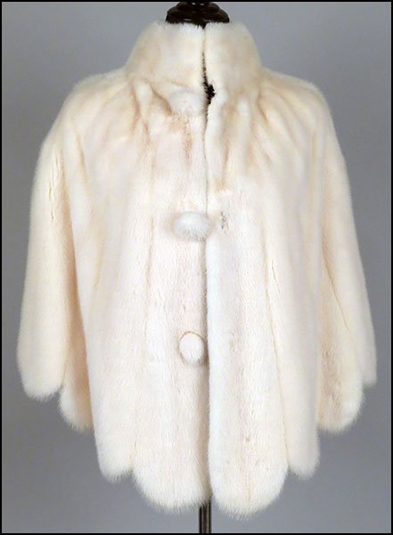 A WHITE MINK CAPE.: A WHITE MINK CAPE. Labeled "The Carol and Irwin Ware Fur Collection at I. Magnin"