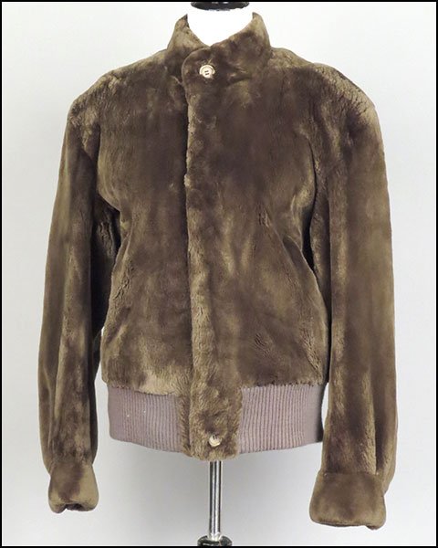 AN I. MAGNIN BROWN SHEARED BEAVER BOMBER JACKET.: AN I. MAGNIN BROWN SHEARED BEAVER BOMBER JACKET. Lined. Bearing a 'The Carol and Irwin Ware Fur Collection' tag. Bearing a partially knit bottom. With a button up front Size unlabeled