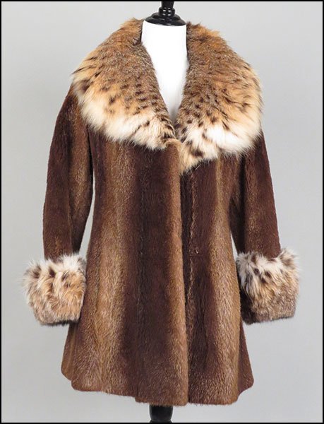 A DONALD BROOKS FOR BLUM'S VOGUE SHEARED BEAVER CAR COA: A DONALD BROOKS FOR BLUM'S VOGUE SHEARED BEAVER CAR COAT. Collar and cuffs trimmed in lynx, hook and eye closure, lined Approx. size 2-4