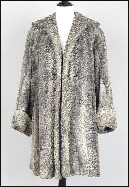 A GREY PERSIAN LAMB SWING COAT.: A GREY PERSIAN LAMB SWING COAT. Spread collar and foldover bell cuffs Size: 6-8