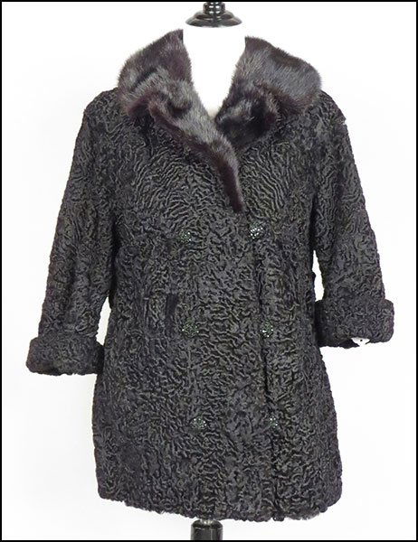 A BLACK PERSIAN LAMB DOUBLE BREASTED JACKET.: A BLACK PERSIAN LAMB DOUBLE BREASTED JACKET. Trimmed in black mink, labeled Bruno and Joseph Furs Chicago, with rear attached belt