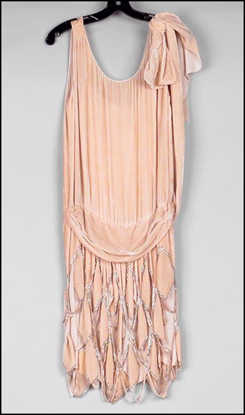 A HATTIE CARNEGIE ORIGINALS ART DECO VELVET AND SILK DR: A HATTIE CARNEGIE ORIGINALS ART DECO VELVET AND SILK DROP WAIST DRESS. Bearing beaded decoration and a geometric cut motif on the skirt. Lined. Bearing the original label Size unlabeled