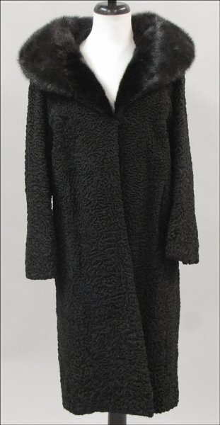 A BLACK PERSIAN LAMB 3/4 LENGTH COAT.: A BLACK PERSIAN LAMB 3/4 LENGTH COAT. With a black mink collar. Labeled 'May-D&F'