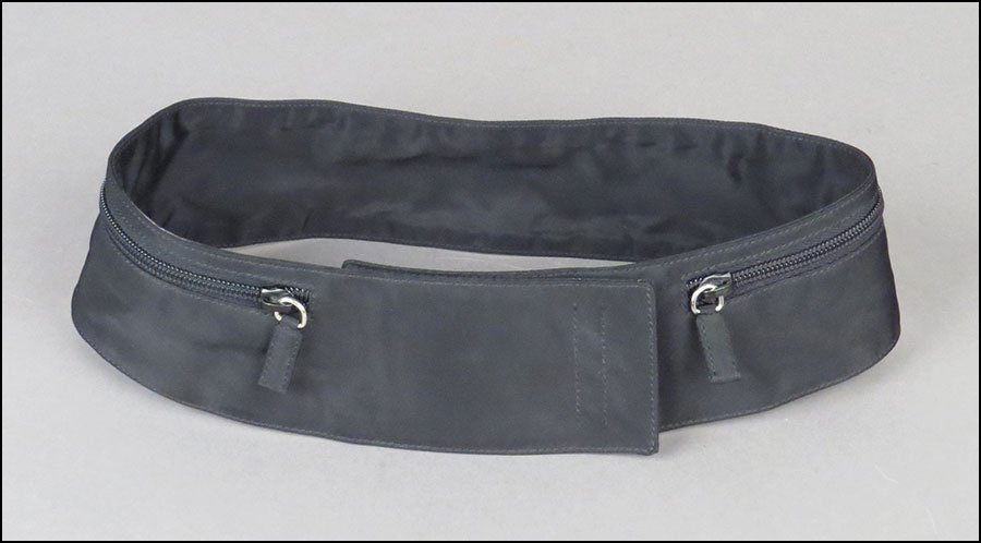 A PRADA BLACK NYLON BELT.: A PRADA BLACK NYLON BELT. Bearing a velcro closure, with zipper pockets on either side. Made in Italy Size unlabeled. L: 31''