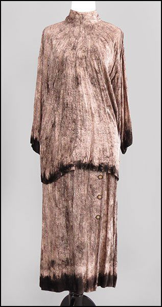 AN ISSEY MIYAKE TWO-PIECE VELVET ENSEMBLE.: AN ISSEY MIYAKE TWO-PIECE VELVET ENSEMBLE. Comprised of a bloused shirt with a mock neck and a skirt with an elasticized waist and button embellishments Size: Small