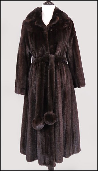 A BLACK MINK FULL-LENGTH SWING COAT.: A BLACK MINK FULL-LENGTH SWING COAT. Bearing a self belt with pom pom ends. Lined. Labeled 'Modele Couture Paris, Resmann, Saltzburg' Size unlabeled // Approximately a size 6