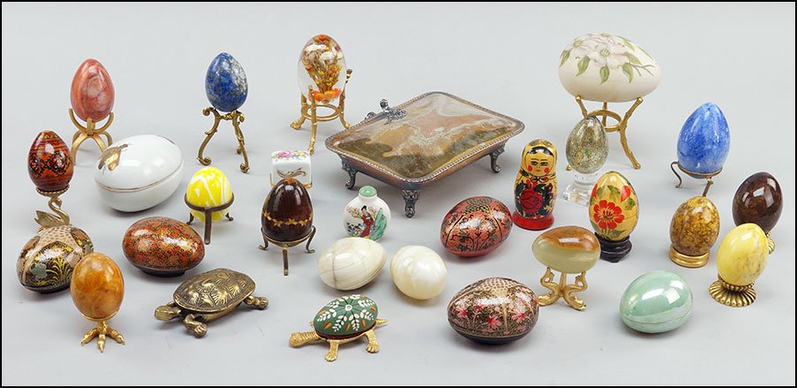 A GROUP OF DECORATIVE EGG FORM BOXES AND SHAPES.: A GROUP OF DECORATIVE EGG FORM BOXES AND SHAPES. Some raised in stands. Including one onyx and one sodalite egg. Over twelve egg forms in all. Together with a silverplate box, a snuff bottle, and one