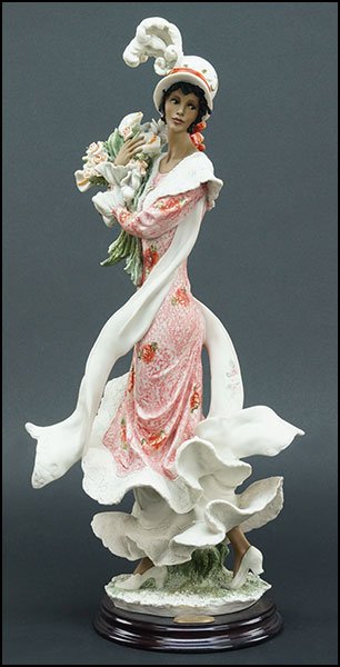GIUSEPPE ARMANI 'LADY WITH FLOWERS' PORCELAIN FIGURE.: GIUSEPPE ARMANI 'LADY WITH FLOWERS' PORCELAIN FIGURE. Signed on the sculpture. Copyright Florence 1997. Edition 238/3000. Bearing the Capodimonte 'N' crown stamp. Raised on a wood base Figure H: 18.5'