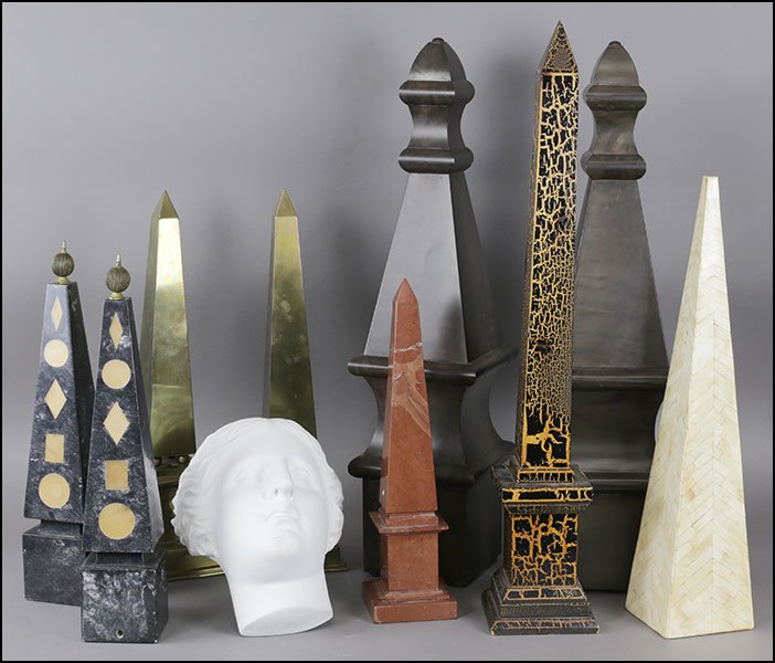 A COLLECTION OF OBELISKS.: A COLLECTION OF OBELISKS. Comprising a pair of brass, a pair of stone, a pair of metal, and three others. Together with a painted ceramic figural wall hanging Tallest obelisk: 32"