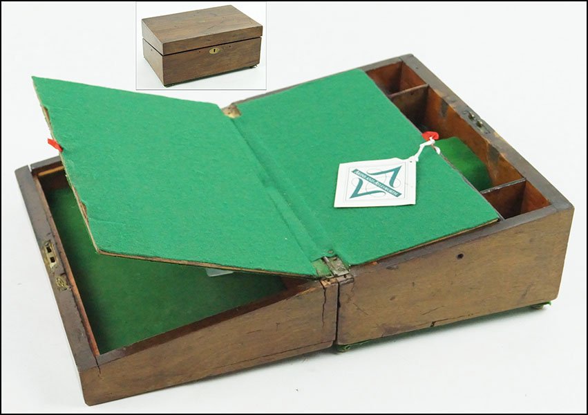 AN ENGLISH MAHOGANY LAP DESK.: AN ENGLISH MAHOGANY LAP DESK. Bearing a brass plate, brass escutcheon, and raised on brass bun feet. Lap desk opens to reveal a green felt interior and fitted compartments 6.5" x 14" x 9"