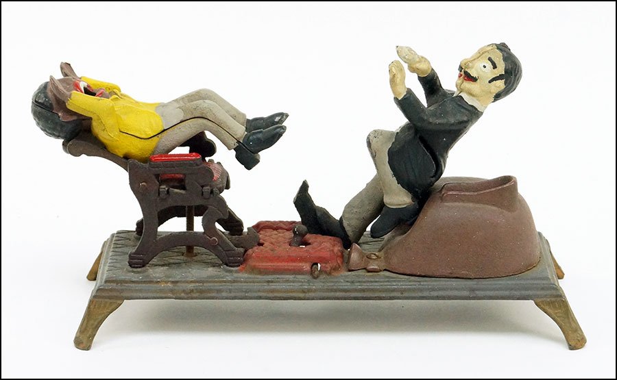 A CRESCENT DENTAL MFG. CO PAINTED CAST IRON FIGURAL: A CRESCENT DENTAL MFG. CO PAINTED CAST IRON FIGURAL BANK. One of 300 banks made for the Dental Association Conference held in Saint Louis, MO in 1955 15.25'' x 9'' x 3.25''