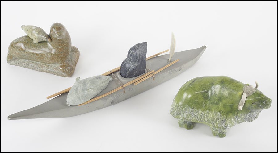 GROUP OF INUIT STONE CARVINGS.: GROUP OF INUIT STONE CARVINGS. Comprised of a fisherman with a dead seal, a mother and child seal group, and a yak. Fisherman and seal bear a signature below Boat length: 17"