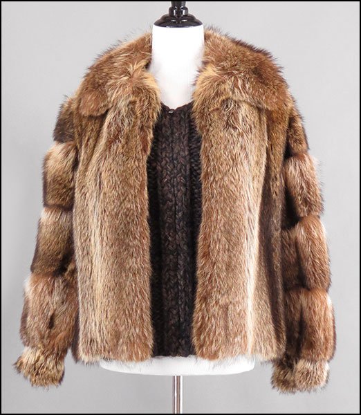 A BONWIT TELLER RACCOON AND WOOL JACKET AND VEST SET.: A BONWIT TELLER RACCOON AND WOOL JACKET AND VEST SET. Comprised of a cableneck wool zip sweater with raccoon fur tiered sleeves and a raccoon fur vest, bearing a hook and eye closure. Labeled Size unl