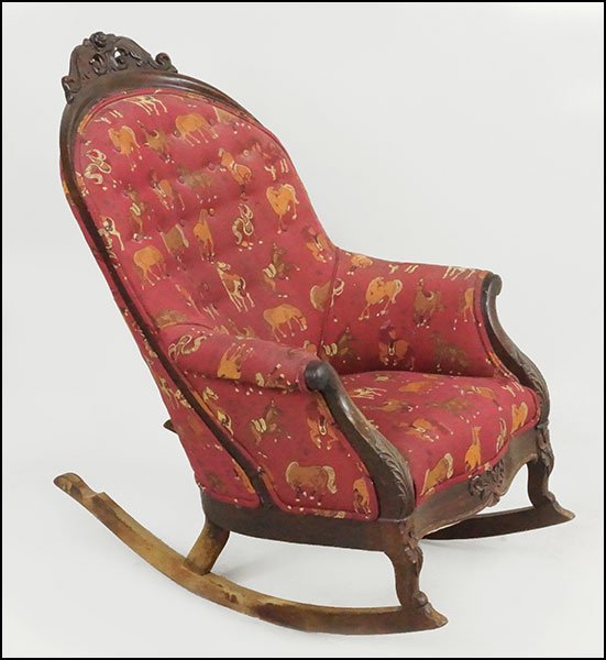 A CARVED ROSEWOOD ROCKING CHAIR.: A CARVED ROSEWOOD ROCKING CHAIR. Rocker is upholstered in an animal print motif Approximately: 42" x 29" x 26"