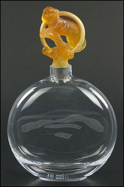 A DAUM CRYSTAL DECANTER.: A DAUM CRYSTAL DECANTER. Bearing a pate de verre tiger form stopper, signed 'Daum France' on the reverse With stopper:12" x 7.5" x 2"