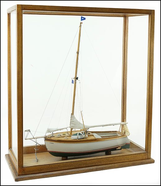 MODEL SAILBOAT.: MODEL SAILBOAT. Mounted in a glass case. Marked C8834. Boat stern displays name 'Raccoon Marblehead.' Approximate boat dimensions: 25" x 20" x 5" Case Dimensions: 27.25" x 25" x 11.5"