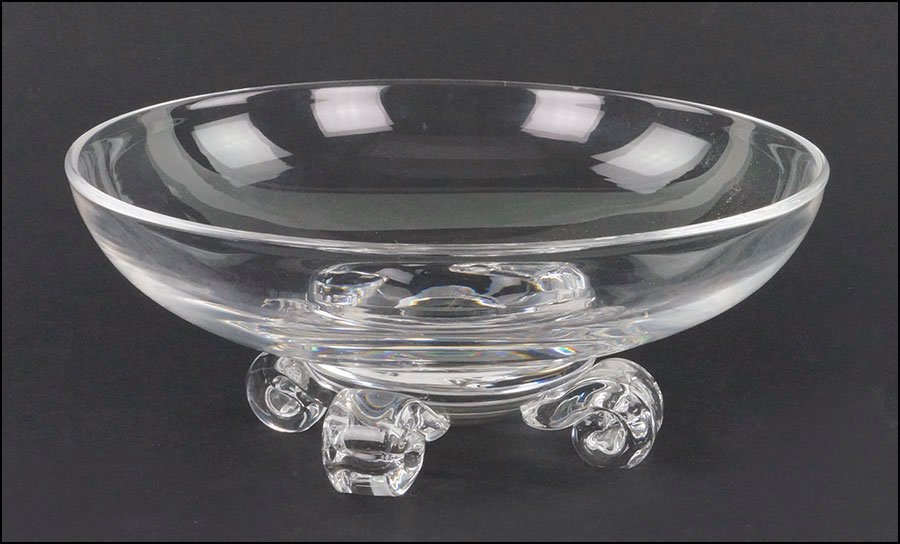 A STEUBEN GLASS LOW BOWL.: A STEUBEN GLASS LOW BOWL. Bearing four scroll form feet and an etched maker's mark on the underside 3" x 7.5"