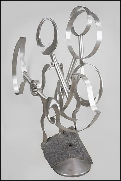 BRUCE STILLMAN (AMERICAN, B. 1958) A KINETIC SCULPTURE.: BRUCE STILLMAN (AMERICAN, B. 1958) A KINETIC SCULPTURE. Four stainless steel kinetic balance weights sit within a stainless steel three-arm and stone base. One support arm is signed and dated "Stillma