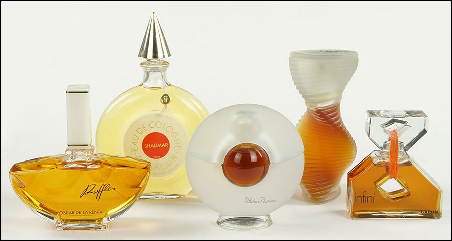 A COLLECTION OF FIVE GLASS PERFUME BOTTLES.: A COLLECTION OF FIVE GLASS PERFUME BOTTLES. Comprising a Shalimar Guerlain, a Paloma Picasso, an Oscar de la Renta 'Ruffles', an 'Infini' by Caron, and a 'Montana' perfume Tallest: 7.75"
