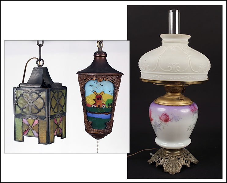 TWO METAL OVERLAY AND SLAG GLASS HANGING LIGHT: TWO METAL OVERLAY AND SLAG GLASS HANGING LIGHT FIXTURES. One bearing a village scene, one of lantern form. Together with a painted porcelain table lamp converted from an oil lamp