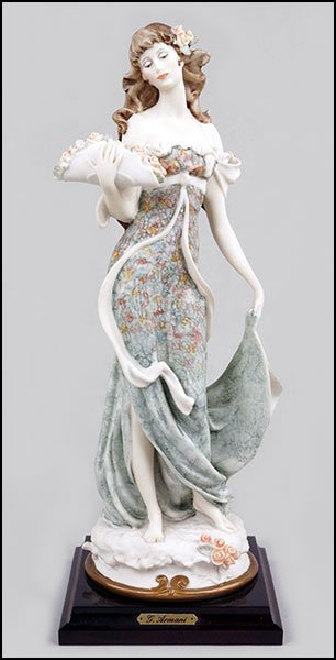 A GIUSEPPE ARMANI FIGURE 'LADY WITH FLOWERS IN HER: A GIUSEPPE ARMANI FIGURE 'LADY WITH FLOWERS IN HER HAT'. A 1992 events figure, signed on the figure base, mounted to a wood base. With original box Height with base: 13.5"