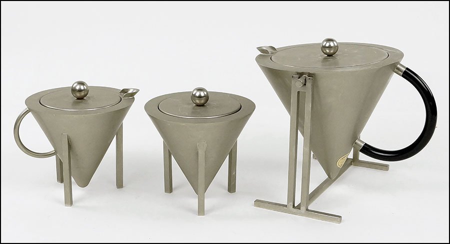 A MONTAGNANI L & C TEA SET.: A MONTAGNANI L & C TEA SET. Stainless steel in the 'Arch.E.Pest' pattern. Comprising a tea kettle with stand, a sugar, and a creamer Kettle on stand: 7" x 8" x 8.5"