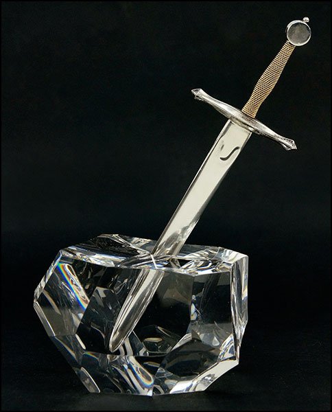 A STEUBEN 'EXCALIBUR' PAPERWEIGHT AND LETTER OPENER.: A STEUBEN 'EXCALIBUR' PAPERWEIGHT AND LETTER OPENER. Designed by James Houston for Steuben. Glass paperweight and a sterling silver and 18 karat yellow gold sword form letter opener. Bearing etched ma