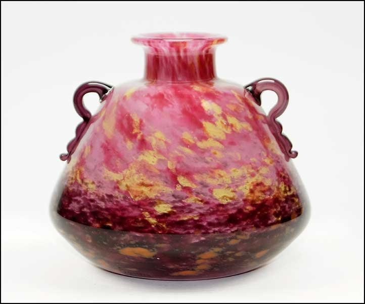 A CHARLES SCHNEIDER MOTTLED GLASS SQUAT VASE.: A CHARLES SCHNEIDER MOTTLED GLASS SQUAT VASE. Colors fade from pink and yellow into an orange / purple towards the underside. Applied amethyst glass handles. Underside bears an etched "Schneider" sign