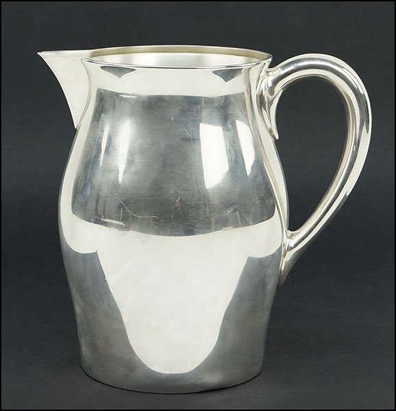 A REED & BARTON STERLING SILVER PITCHER.: A REED & BARTON STERLING SILVER PITCHER. Stamped on the underside with maker's mark, 'Paul Revere Reproduction', and the number x758 Height: 7.75" Weight: 20.7 ozt