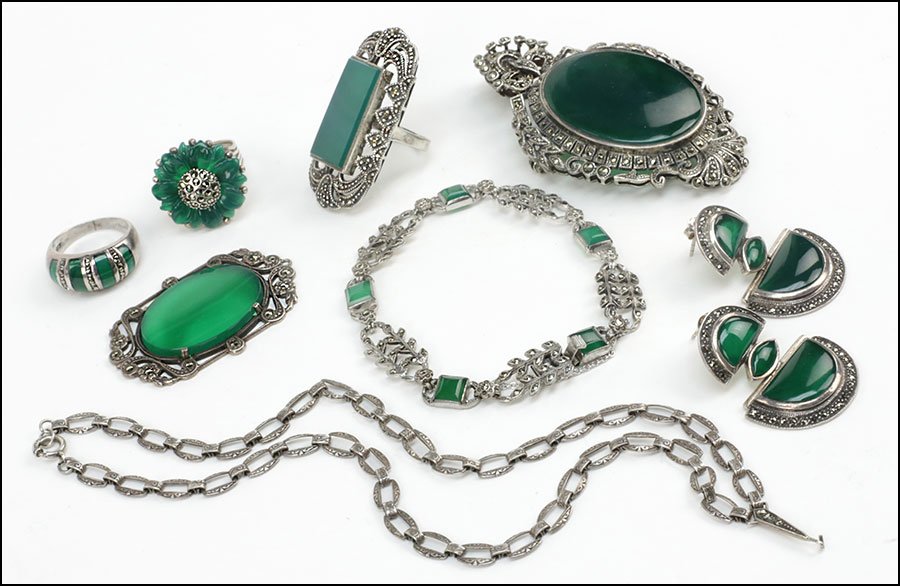 A COLLECTION OF STERLING SILVER, MARCASITE, AND GREEN: A COLLECTION OF STERLING SILVER, MARCASITE, AND GREEN ONYX JEWELRY. Comprising a necklace, a pendant brooch, a bracelet, a pair of post back earrings, and three rings