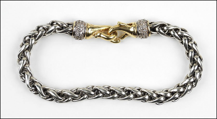 A DAVID YURMAN DIAMOND, 18 KARAT YELLOW GOLD, AND: A DAVID YURMAN DIAMOND, 18 KARAT YELLOW GOLD, AND STERLING SILVER 'WHEAT CHAIN' BRACELET. Containing two rows of round diamonds adjacent to each clasp Length: 7.5" Weight: 29.8 grams