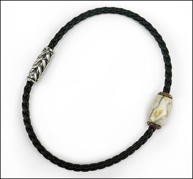 A DAVID YURMAN 'OJIME' BRACELET.: A DAVID YURMAN 'OJIME' BRACELET. Sterling silver clasp, leather cording, and a central semi precious stone with sterling silver caps Length: 8.75"