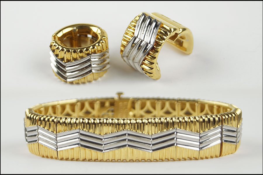 A MICHAEL BONDANZA PLATINUM AND 18 KARAT YELLOW GOLD: A MICHAEL BONDANZA PLATINUM AND 18 KARAT YELLOW GOLD DEMI-PARURE. Comprising a bracelet and pair of earclips in the 'Heat Wave' pattern Length: 7.5" Total weight: 92.1 grams