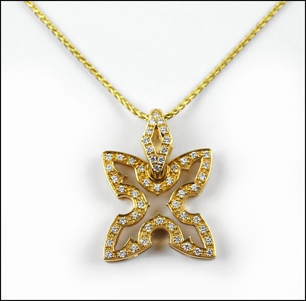 A STEPHEN WEBSTER DIAMOND AND 18 KARAT YELLOW GOLD: A STEPHEN WEBSTER DIAMOND AND 18 KARAT YELLOW GOLD NECKLACE. Pendant contains 52 diamonds Length: 16" Weight: 6.8 grams