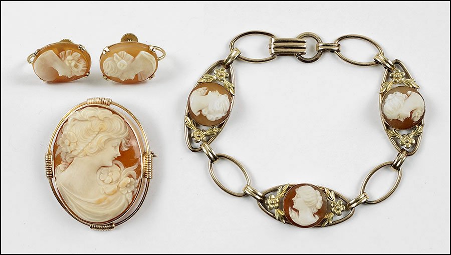 A SHELL CAMEO AND 14 KARAT YELLOW GOLD BROOCH /: A SHELL CAMEO AND 14 KARAT YELLOW GOLD BROOCH / PENDANT. Together with a pair of shell cameo and 14 karat yellow gold screwback earrings, and a shell cameo and gold filled bracelet Brooch: 1.5" 1.25"