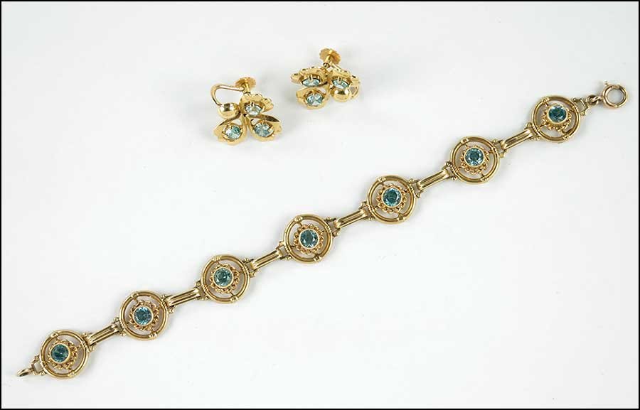 A BLUE ZIRCON AND 14 KARAT YELLOW GOLD BRACELET.: A BLUE ZIRCON AND 14 KARAT YELLOW GOLD BRACELET. Containing seven circle segments alternating between six links. Each circle segment contains one round blue zircon. Together with a pair of 14 karat ye