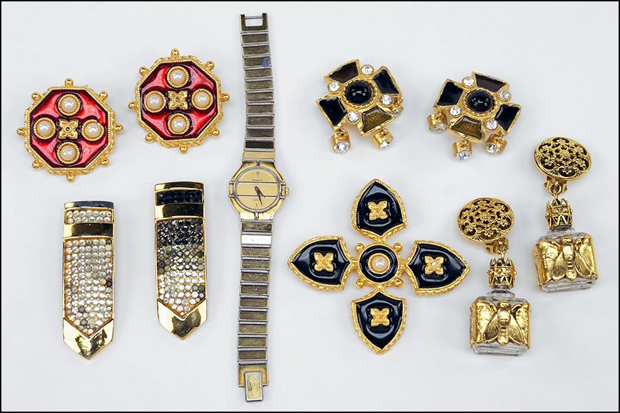 A COLLECTION OF GOLDTONE JEWELRY.: A COLLECTION OF GOLDTONE JEWELRY. Containing a Movado watch, two pairs of Yosca earclips, a Yosca brooch, two Judith Leiber fur clips, and an addional pair of drop earclips