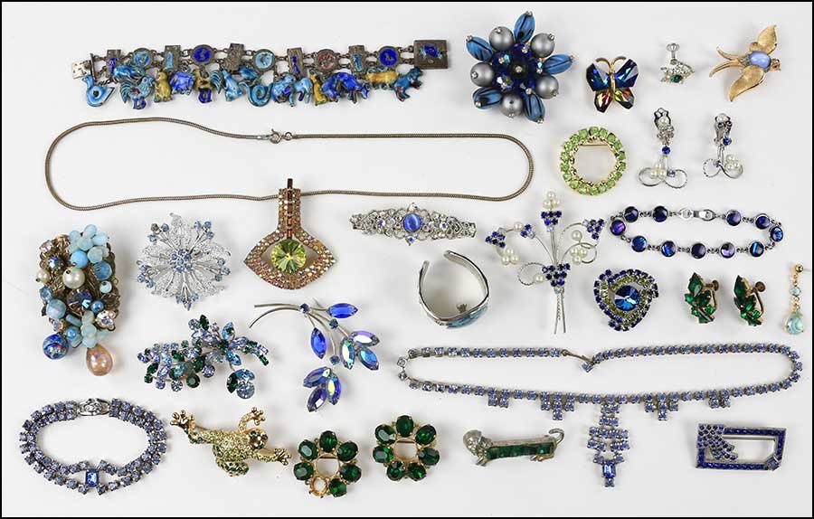 A COLLECTION OF BLUE AND GREEN RHINESTONE JEWELRY.: A COLLECTION OF BLUE AND GREEN RHINESTONE JEWELRY. Containing necklaces, bracelets, brooches, earrings, and ear clips. Signed pieces include those by Trifari, Monet, and others