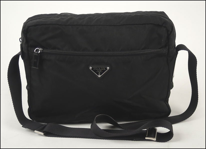 A PRADA NYLON CROSS BODY MESSENGER BAG.: A PRADA NYLON CROSS BODY MESSENGER BAG. Containing adjustable strap H: 8" W: 13" D: 4"