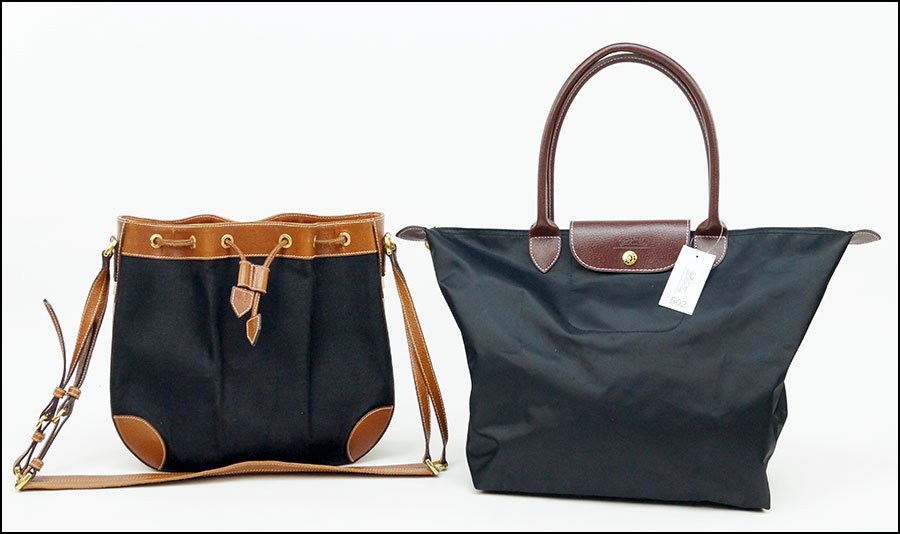 A GUCCI CANVAS AND LEATHER BUCKET DRAWSTRING BAG.: A GUCCI CANVAS AND LEATHER BUCKET DRAWSTRING BAG. Containing goldtone hardware. Together with a black Longchamp canvas and leather tote H: 11" W: 12" D: 3"