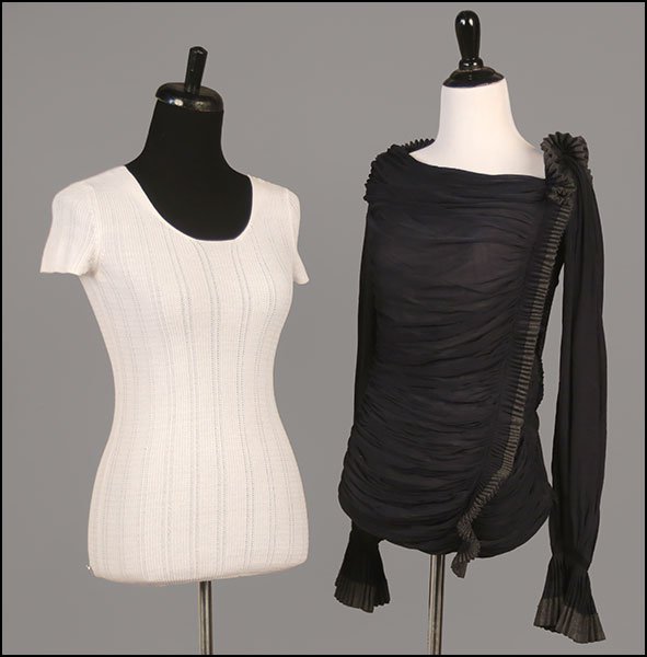 A CHANEL RIBBED AND KNIT WHITE COTTON SHIRT.: A CHANEL RIBBED AND KNIT WHITE COTTON SHIRT. With goldtone Chanel emblem attached to bottom right. Together with a Donna Karan long-sleeved frill blouse