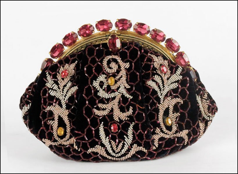 A HATTIE CARNEGIE FRENCH BEADED VELVET CLUTCH HANDBAG.: A HATTIE CARNEGIE FRENCH BEADED VELVET CLUTCH HANDBAG. Exterior is adorned with seed beads and bugle beads, with applied yellow and red rhinestones. Frame and closure of handbag are formed by prong se