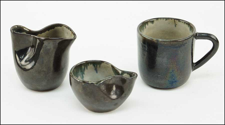 EUGENE DEUTCH (AMERICAN, 20TH CENTURY) THREE GLAZED: EUGENE DEUTCH (AMERICAN, 20TH CENTURY) THREE GLAZED POTTERY PIECES. Comprising one handled mug, a larger cup, and a smaller cup (possibly a creamer and sugar). All are signed and dated 1948 on the und